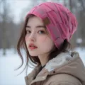 Detailed view of the cozy pink knitted winter beanie with plush lining and a stylish leather label. - Mixed Magenta