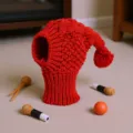 Red knitted pet hat, warm cable knit dog snood with pom-pom, cute winter pet apparel detail view. - S / Red