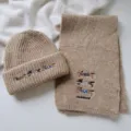 Detail shot of the cute dachshund embroidered knit scarf and beanie set in beige wool blend. - Set / Khaki