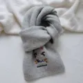 Close-up view of the grey knit scarf featuring cute dachshund embroidery and cozy texture. - Scarf / Gray