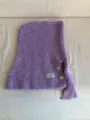 Detailed view of the purple wool knit balaclava hood scarf featuring stylish buttons and logo patch. - Purple