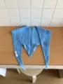 Blue wool knit triangular scarf detail, cozy winter shawl with delicate woven pattern texture. - Sky Blue
