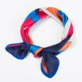 Close-up detail of geometric color block silk scarf showing vibrant multi-color design. - 70x70cm / Blue
