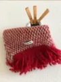 Cozy red and white patterned fuzzy scarf detail with long tassel edge and brand label. - Red