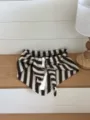 Detailed view of brown white striped knit wool triangular scarf, cozy winter fashion layering. - 115x38cm / Coffee