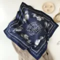 Detailed view of the dark blue silk scarf featuring elegant carriage print and classic polka dots. - Navy Blue Horse