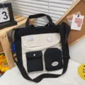 Canvas messenger bag detail showing cute contrast color design with multi-pockets and badges. - No Pendant / Black