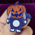 Halloween dark style cat enamel pin detailed close-up shot, trendy quirky cartoon metal brooch badge accessory. - Pumpkin Head Dagger Cat