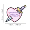 Pink heart dagger enamel pin badge, cute and edgy clothing accessory, detailed shot. - Pink Heart Dagger Style