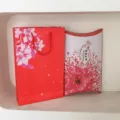 Gift packaging set including red paper bag and pillow gift box with floral design. - 2