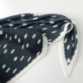 Close-up detail of pleated polka dot silk scarf, elegant neckerchief texture display. - 70x70cm / Pine Green