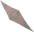 Close-up detail of a stylish pink knitted triangle scarf with green circular TC heart pattern. - 140x30cm / Pink