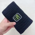 Black knit headband with embroidered patch, cozy winter hair accessory for daily face washing. - Black
