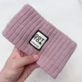Pink knitted hairband with woven patch label, cozy winter hair accessory for daily wear. - Pink