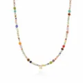 Detail shot of a bohemian colorful beaded necklace with a gold letter pendant and small beads. - Letter S (NE0446 S)