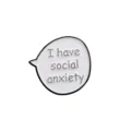 Close-up detail of white speech bubble enamel pin with social anxiety text, metal badge. - I Have Social Anxiety Style