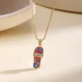 Gold-plated evil eye slipper pendant necklace with red enamel and dazzling rhinestone strap. - Rose Red