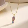 Detailed close-up of the pink enamel evil eye slipper pendant necklace with sparkling rhinestones. - Pink