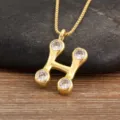 Gold plated letter H pendant necklace featuring sparkling micro set cubic zirconia stones. - Letter H