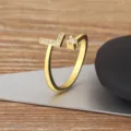 Gold-plated adjustable alphabet L ring featuring micro-paved cubic zirconia stones. - L