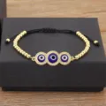 Bracelet oeil malefique plaque or avec zircons cubiques et cordon reglable femme - Noir