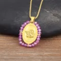 Gold plated oval angel pendant necklace with purple beaded chain for women fashion jewelry. - Pink