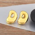 Gold irregular geometric bean stud earrings with sleek polished finish for daily wear - Letter D