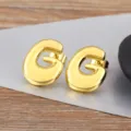 Gold letter G bubble stud earrings for women and men, minimalist fashion shiny jewelry piece. - Letter G