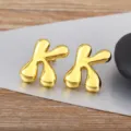 Gold bubble letter earrings, sleek smooth metal minimalist fashion jewelry for daily wear. - Letter K
