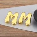 Gold puffy letter M stud earrings, glossy metal minimalist alphabet jewelry for daily wear. - Letter M