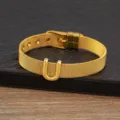 Gold plated mesh bracelet with letter U charm, stylish adjustable metal jewelry accessory. - Letter U