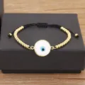 Bracelet mauvais œil avec perles dorées et cordon noir, design de style turc élégant. - Blanc