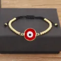 Bracelet mauvais œil en cuivre plaqué or avec perles et émail rouge réglable femme - Rouge