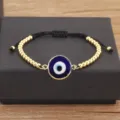 Bracelet mauvais œil plaqué or avec perles en émail bleu et cordon réglable noir. - Bleu foncé