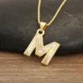 Gold letter M pendant necklace featuring natural mother of pearl and delicate beaded edge. - M