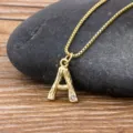 Minimalist 18k gold plated letter A pendant necklace featuring bamboo texture and crystal. - Letter A