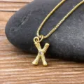 Minimalist 18k gold plated bamboo style letter X pendant necklace with sparkling crystal detail. - Letter X