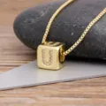 Gold-plated letter U cube pendant necklace sparkling with cubic zirconia stones. - Letter U