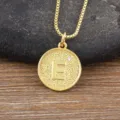 Gold-plated letter E pendant necklace with sparkling cubic zirconia on delicate chain. - Letter E