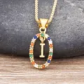 Gold-colored necklace featuring a vibrant multi-color zirconia oval pendant with letter I charm. - Letter I