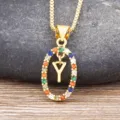 Gold color pendant necklace featuring an oval multi-colored zircon stone design with letter Y charm. - Letter Y