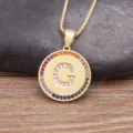 Gold-plated copper necklace featuring a round letter G pendant with colorful cubic zirconia stones. - Letter G