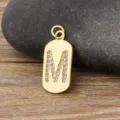 Gold initial M pendant necklace with sparkling cubic zirconia, elegant copper jewelry accessory. - Letter M