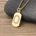 Gold color initial letter O pendant necklace with sparkling cubic zirconia on a chic dog tag. - Letter O