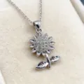 Detailed close-up of a silver-toned rhinestone sunflower pendant necklace with chain - Gold Necklace