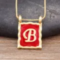 Gold-plated square letter B pendant necklace featuring red enamel and chic chain style. - Letter B