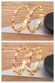 Gold-plated evil eye hoop earrings with sparkling zirconia and red enamel stars for women. - Rose Red