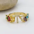 Anello regolabile in rame placcato oro 18K con zirconi colorati lettera T - Lettera T