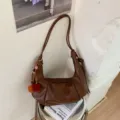 Brown PU hobo shoulder bag with chic pleated design, casual retro dumpling handbag for women. - With Pendant / Brown