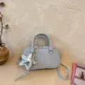 Light blue Boston handbag detail with stylish silver star pendant and comfortable dual top handles. - With Pendant / Blue